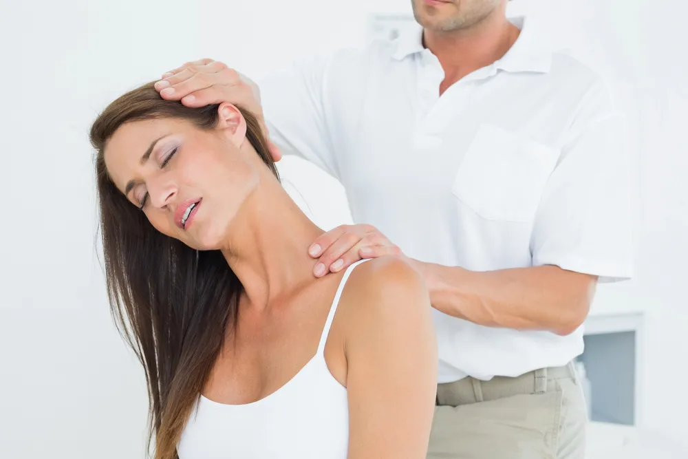 Therapist guiding a patient through a neck stretch